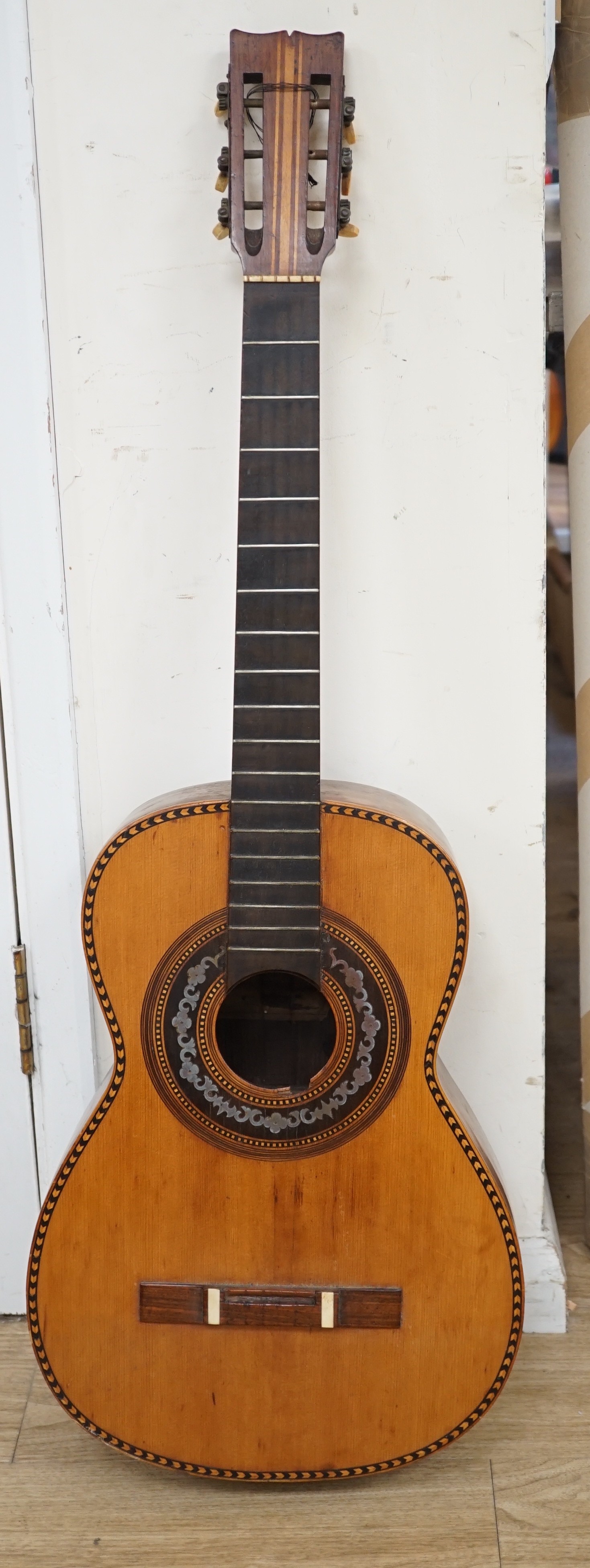 A 19th century Spanish parlour guitar labelled Antonio Carlos Garcia, Madrid. The back 46.5cm excluding button. Lacking strings, with soft case